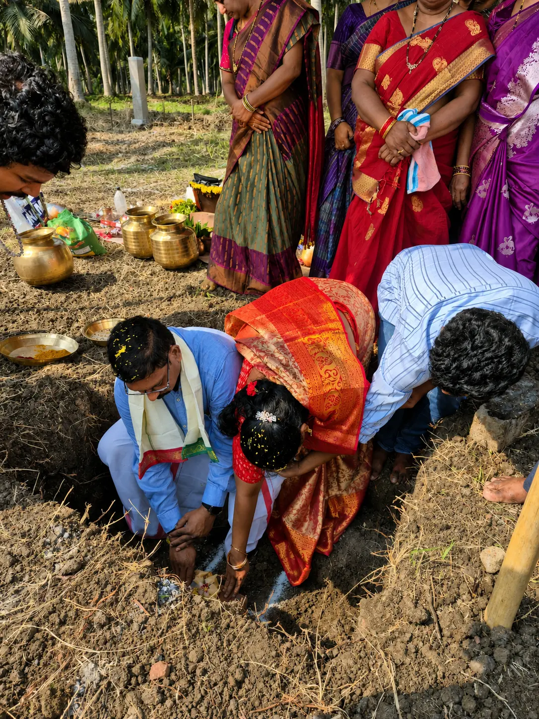 Family placing offerings during the foundation ritual